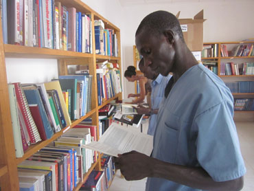 Reading books in the fully stocked library.